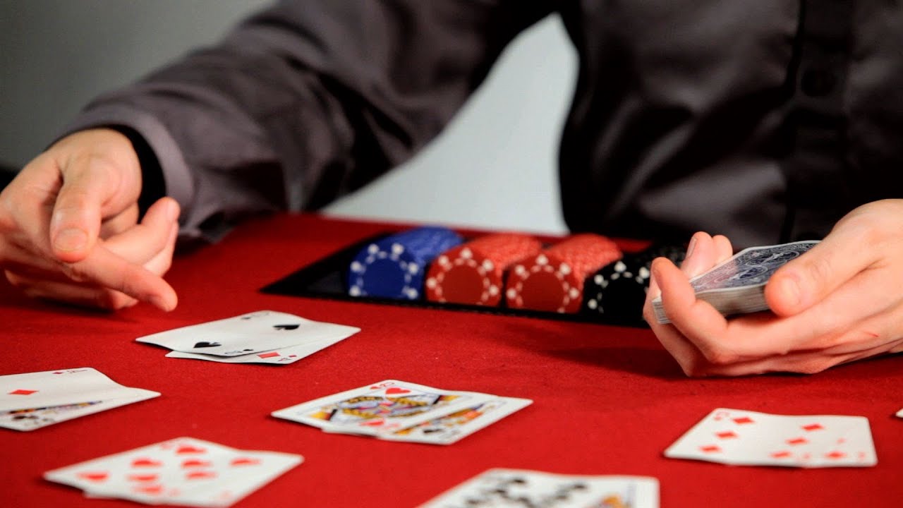 Man playing poker with stacks of chips and hands of cards