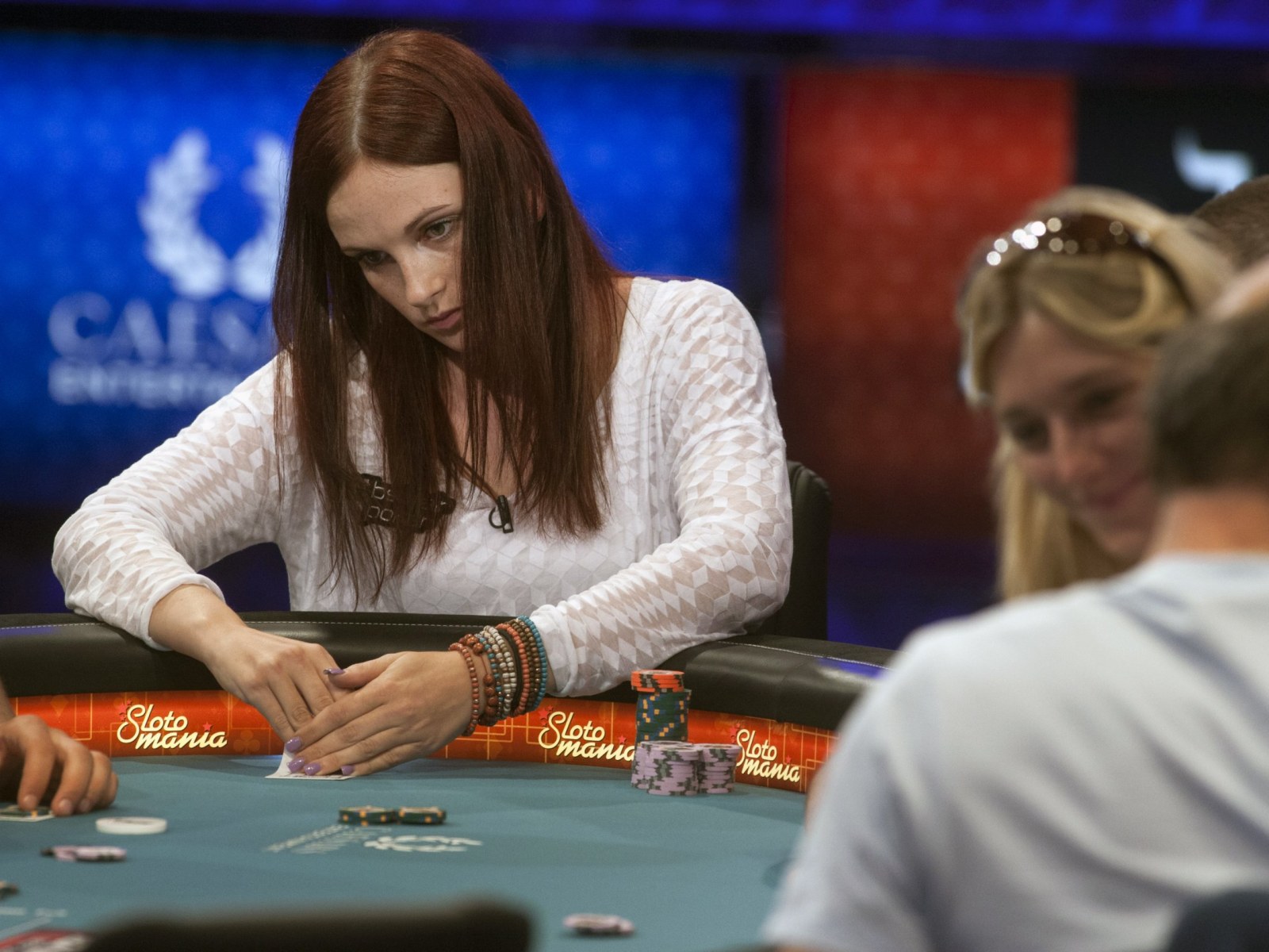 Woman collecting chips during poker game